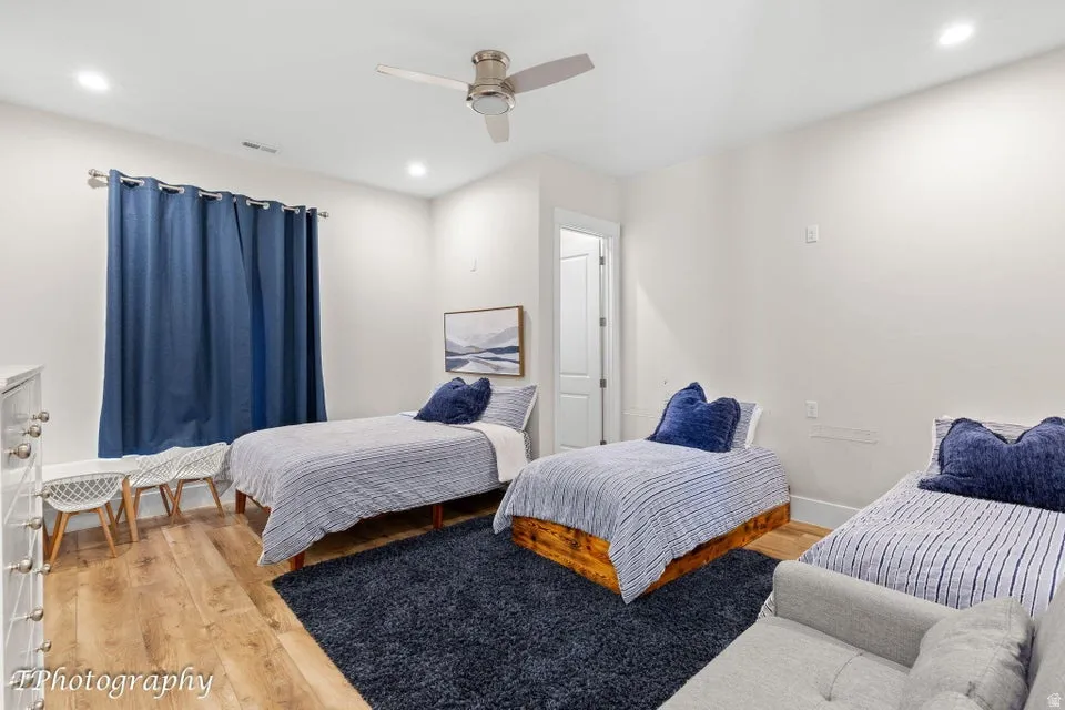 Bedroom featuring light wood-type flooring, ceiling fan, and recessed lighting