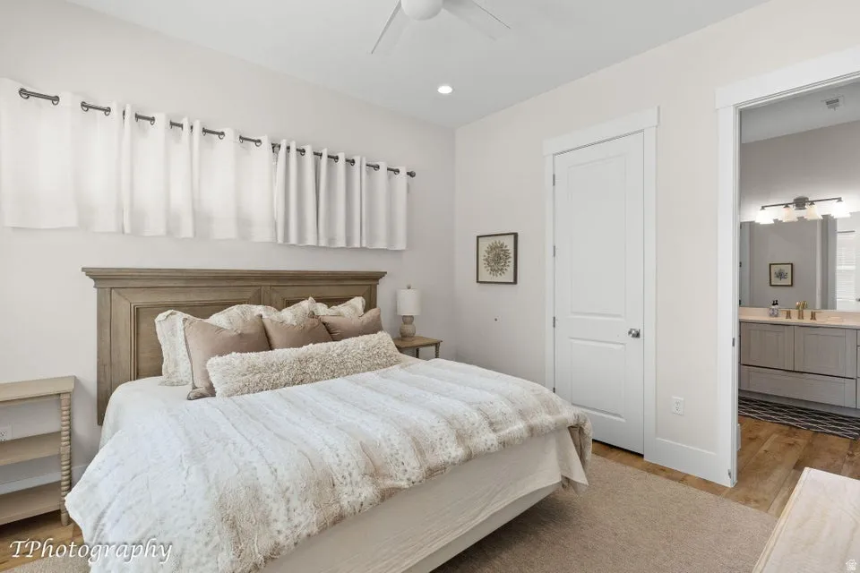 Bedroom featuring light wood-type flooring, recessed lighting, ensuite bathroom, and a ceiling fan