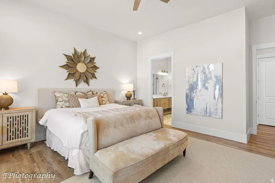 Bedroom featuring light wood-style floors, a ceiling fan, recessed lighting, and connected bathroom