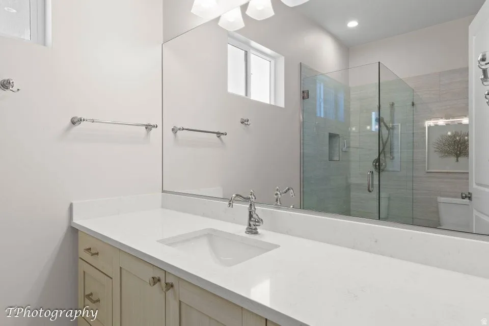 Full bath with vanity and a stall shower