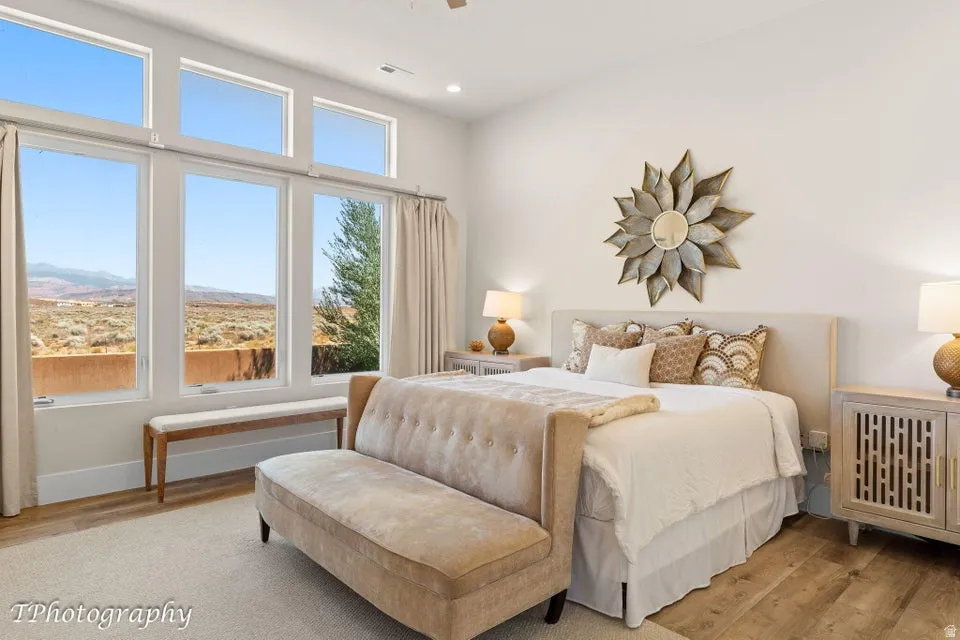 Bedroom with light wood-style floors and recessed lighting