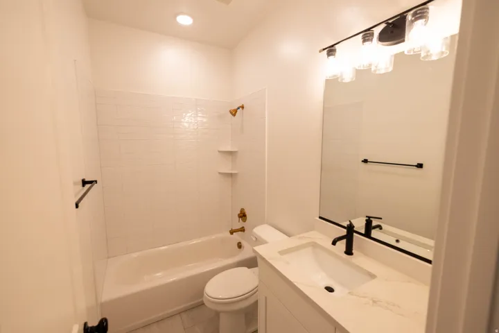 Full bathroom featuring vanity,  shower combination, and recessed lighting
