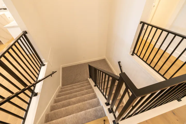 Stairway featuring carpet floors and baseboards
