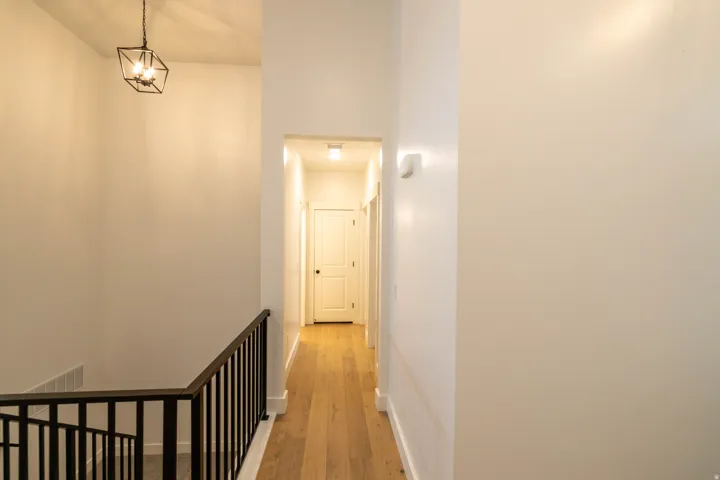 Corridor featuring light wood-type flooring and baseboards