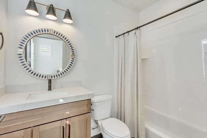 Full bath featuring vanity and shower / bathtub combination with curtain