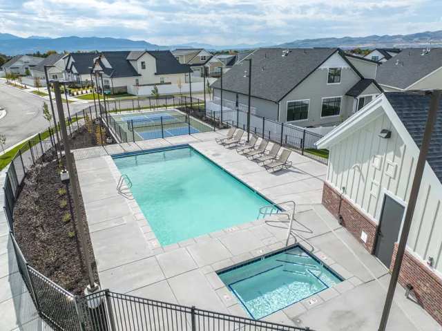 Community pool with a patio area, a residential view, a mountain view, and a hot tub