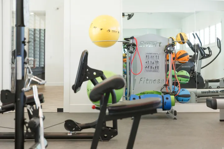 Gym featuring baseboards and rubber floors