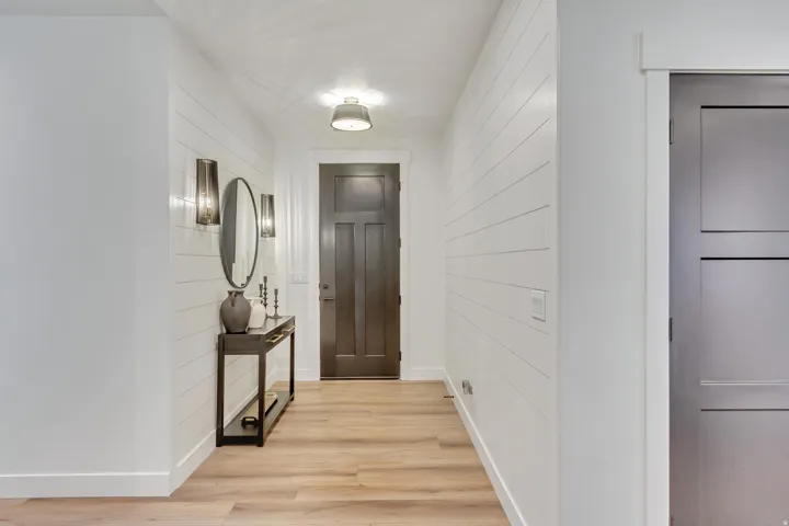 Doorway to outside featuring wooden walls and wood finished floors