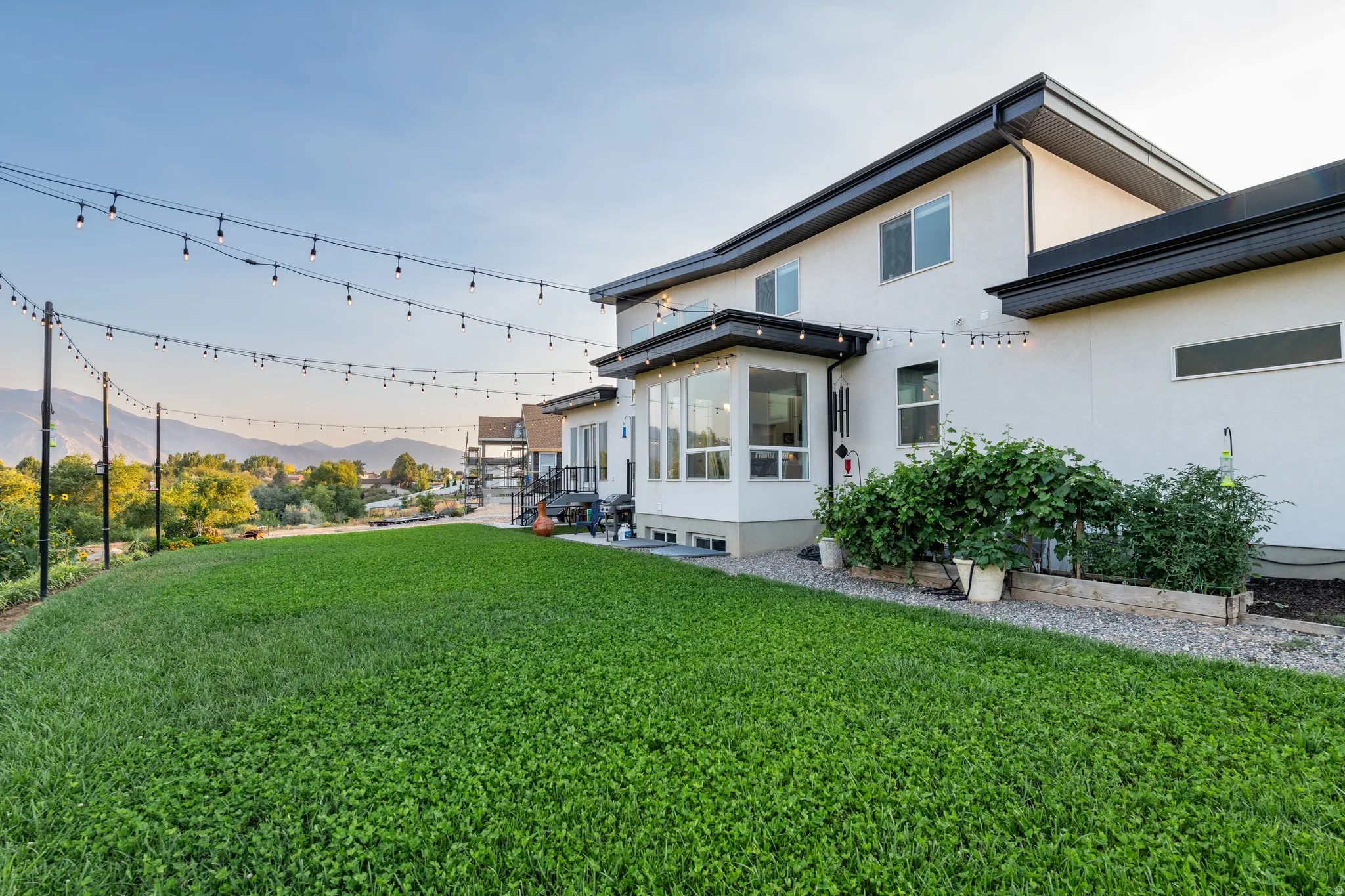 Expansive green lawn with a tiered landscape and mountain scenery