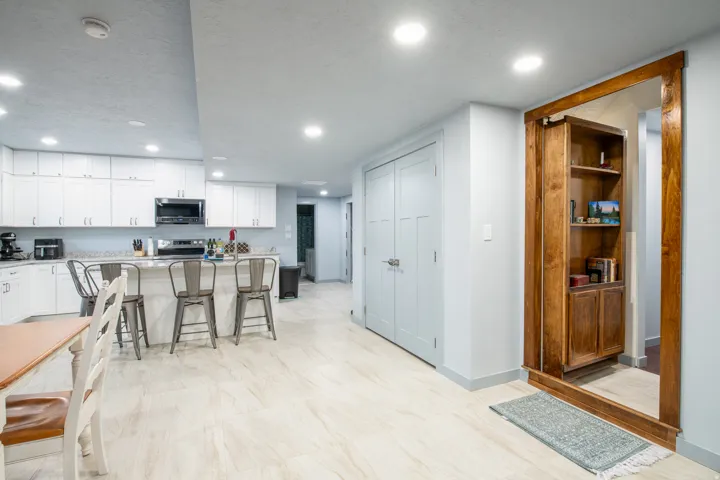 Recessed lighting illuminates wood-finish flooring
