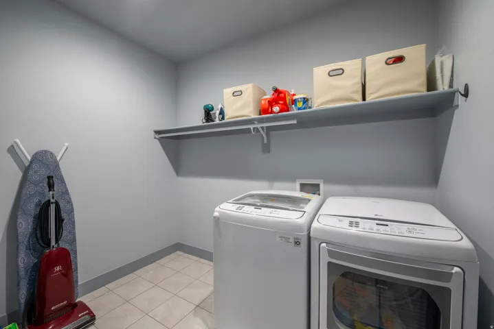 Built-in shelving, tile flooring, and light-toned walls