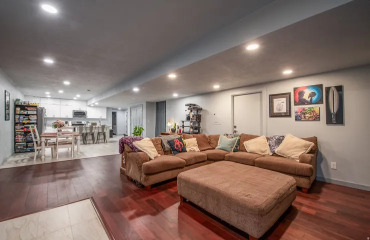 Living area featuring dark wood-type flooring and recessed lighting