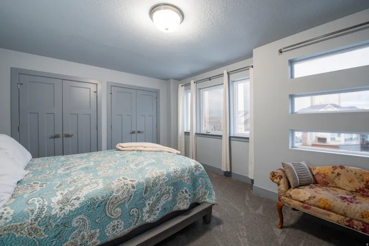 Dual pane windows, custom window treatments, flush mount ceiling light, two paneled closet doors, and plush carpeting