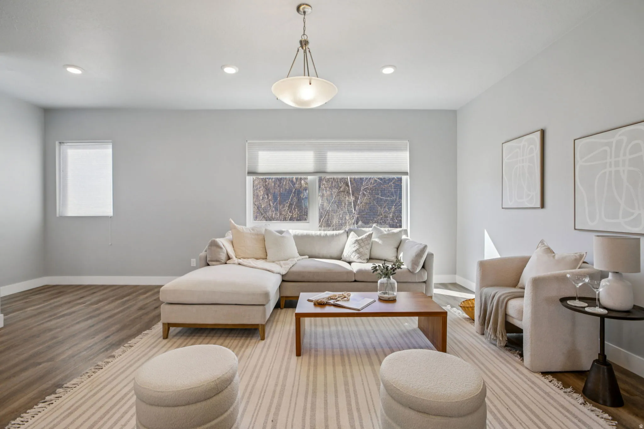 Living room featuring wood finished floors, healthy amount of natural light, and recessed lighting