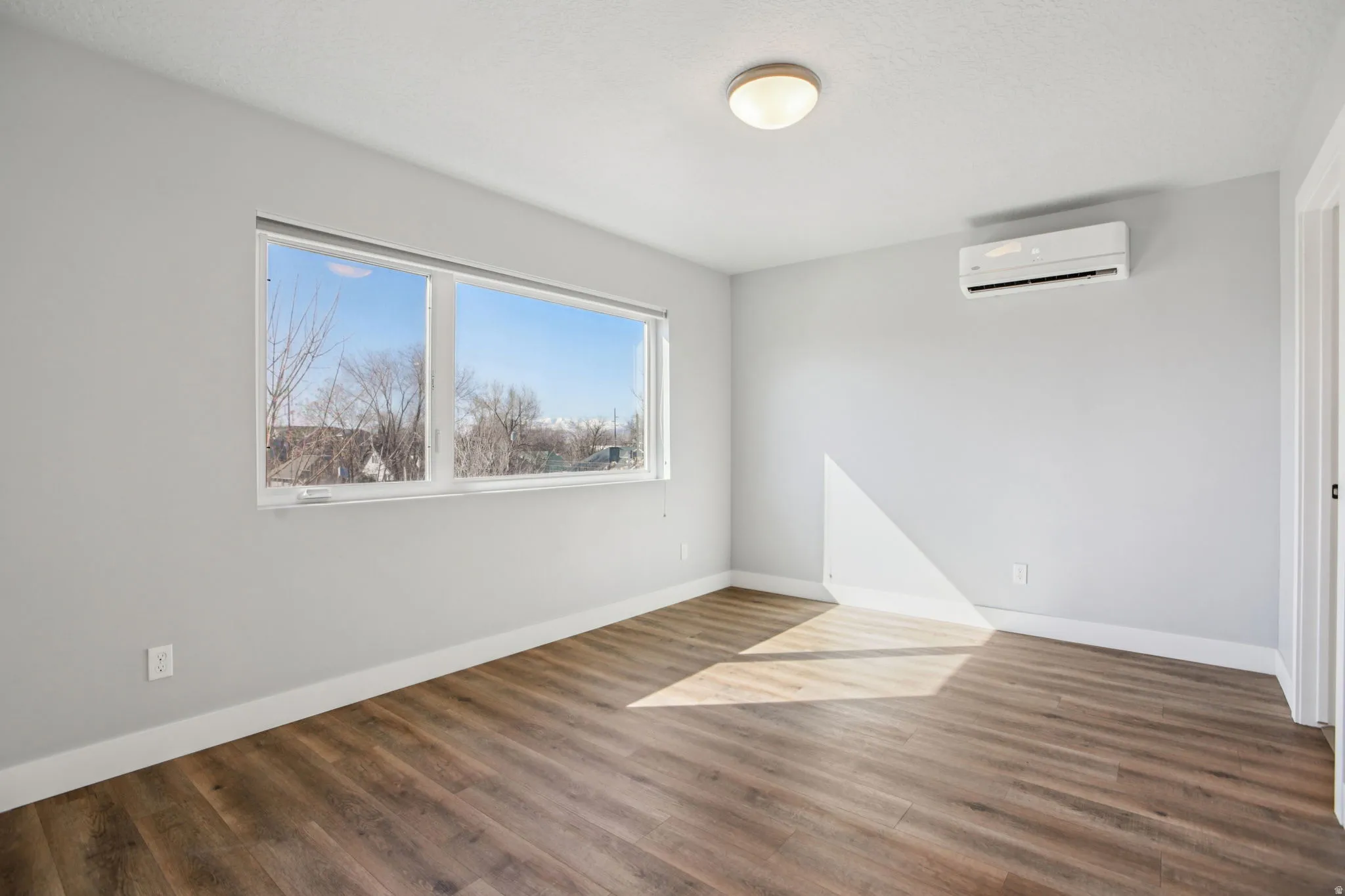 Empty room featuring dark wood-type flooring