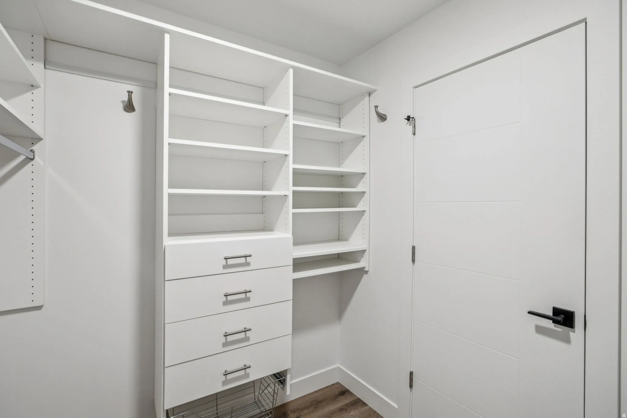 Walk in closet featuring dark wood-type flooring