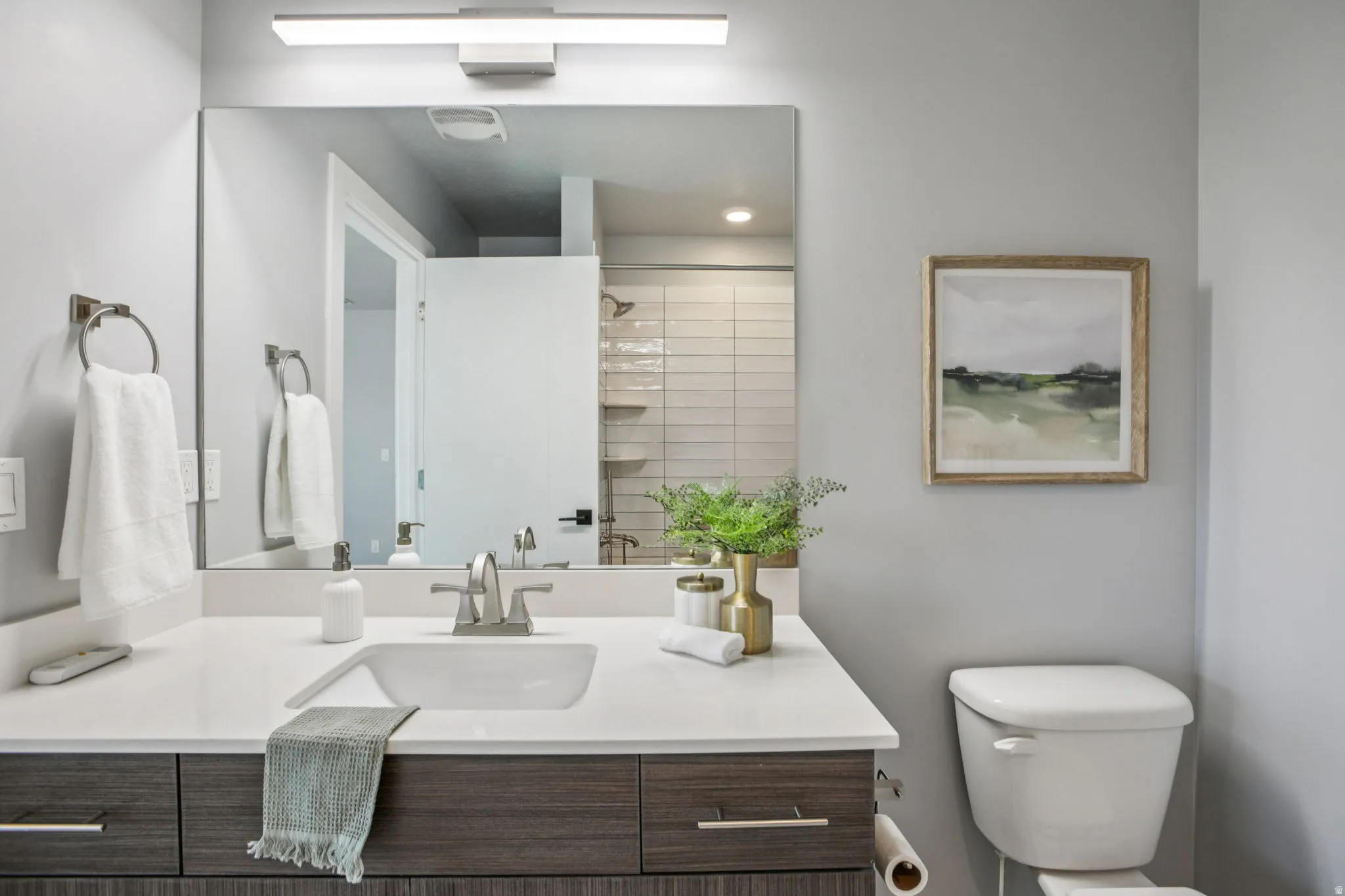Full bathroom featuring tiled shower and vanity