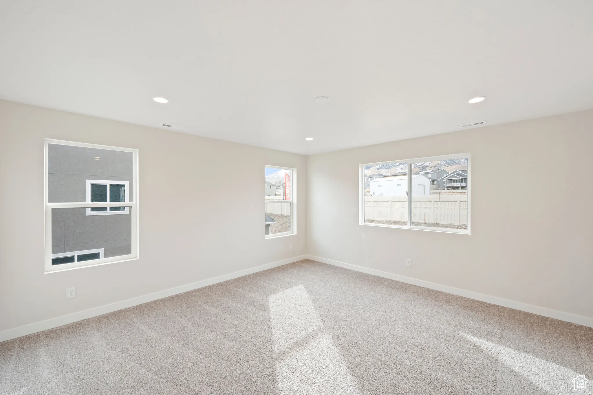 Unfurnished room with light carpet and recessed lighting