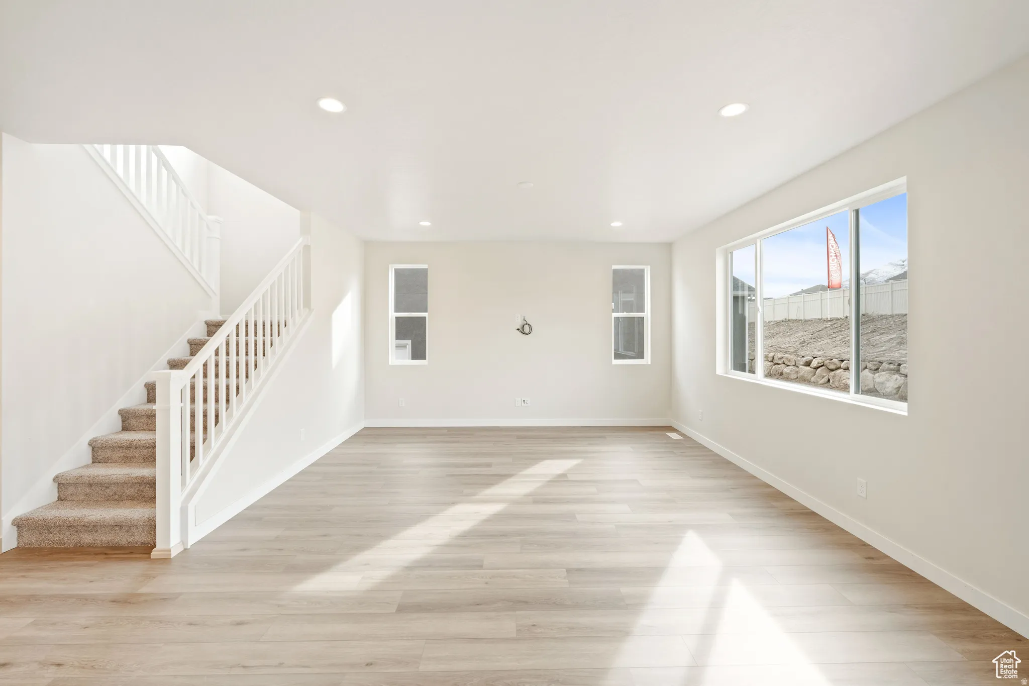 Unfurnished living room with light wood finished floors and recessed lighting