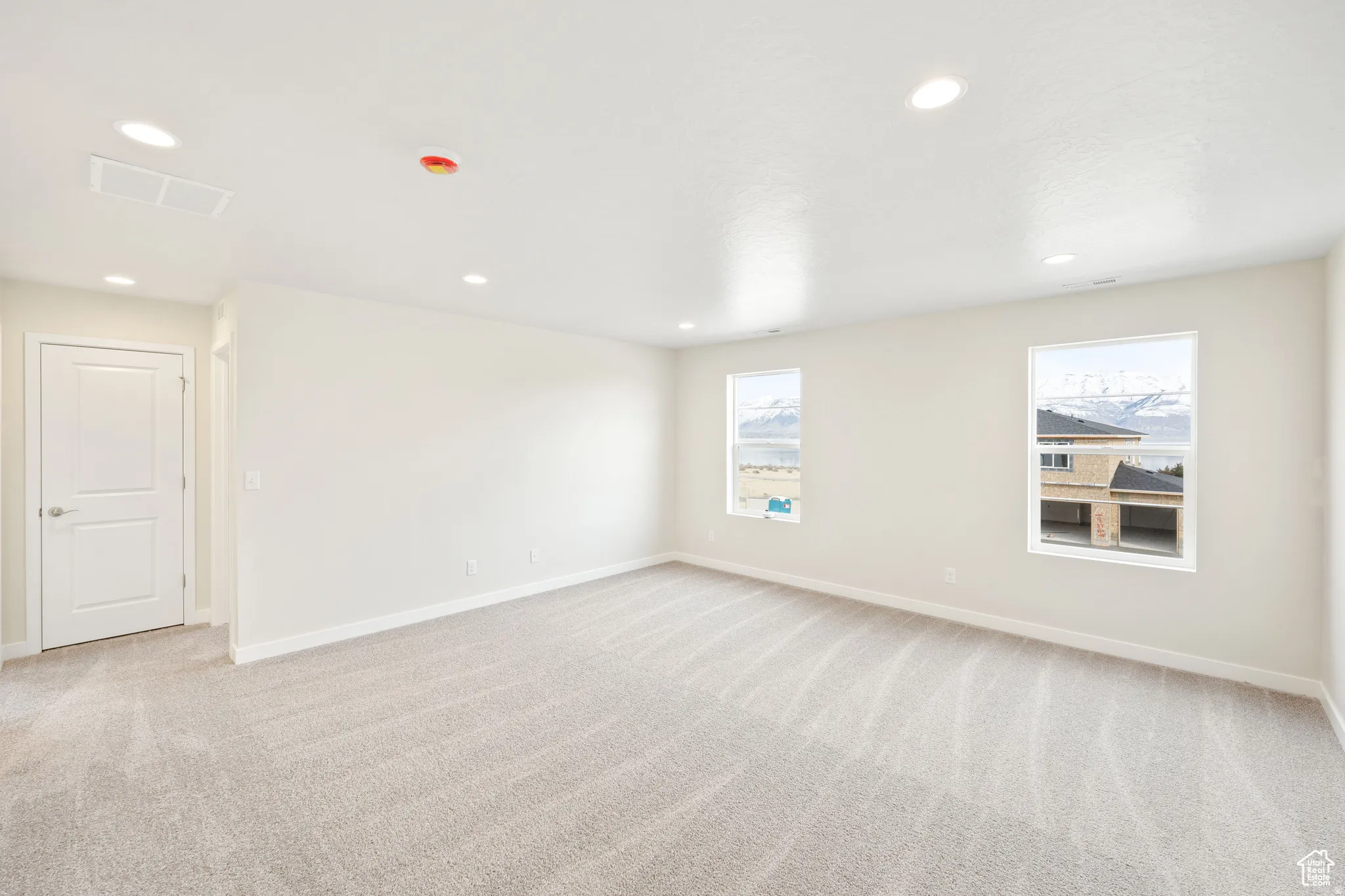 Unfurnished room featuring light carpet and recessed lighting