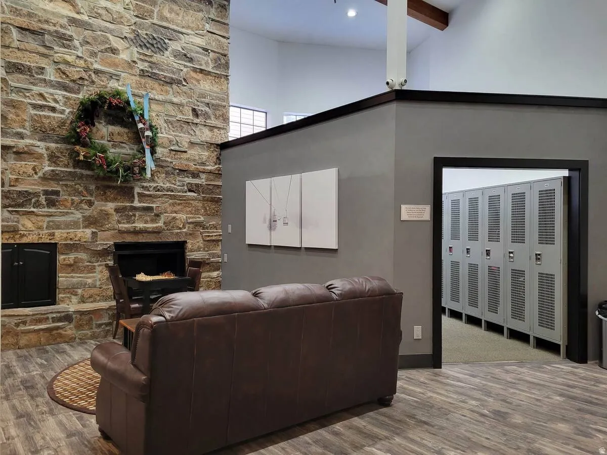 Storage area for an extra fee with a stone fireplace and wood finished floors
