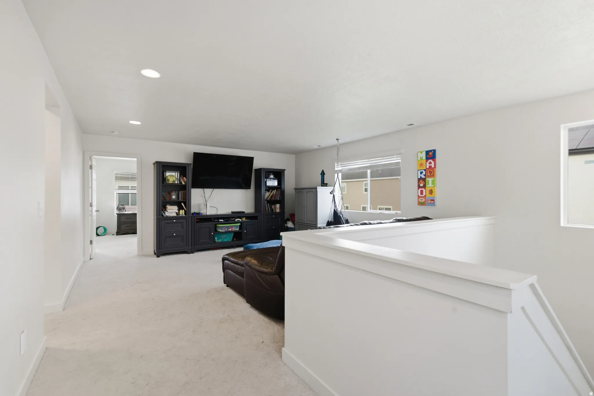 Living room featuring light colored carpet and recessed lighting