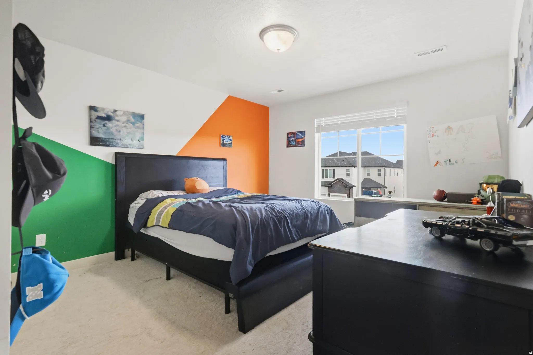 Bedroom featuring light colored carpet and baseboards