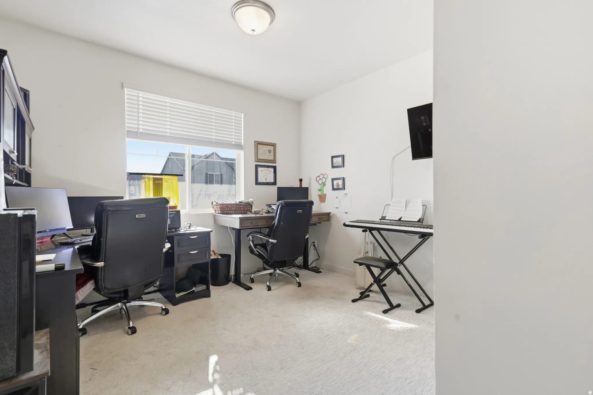 Bedroom/office featuring light carpet