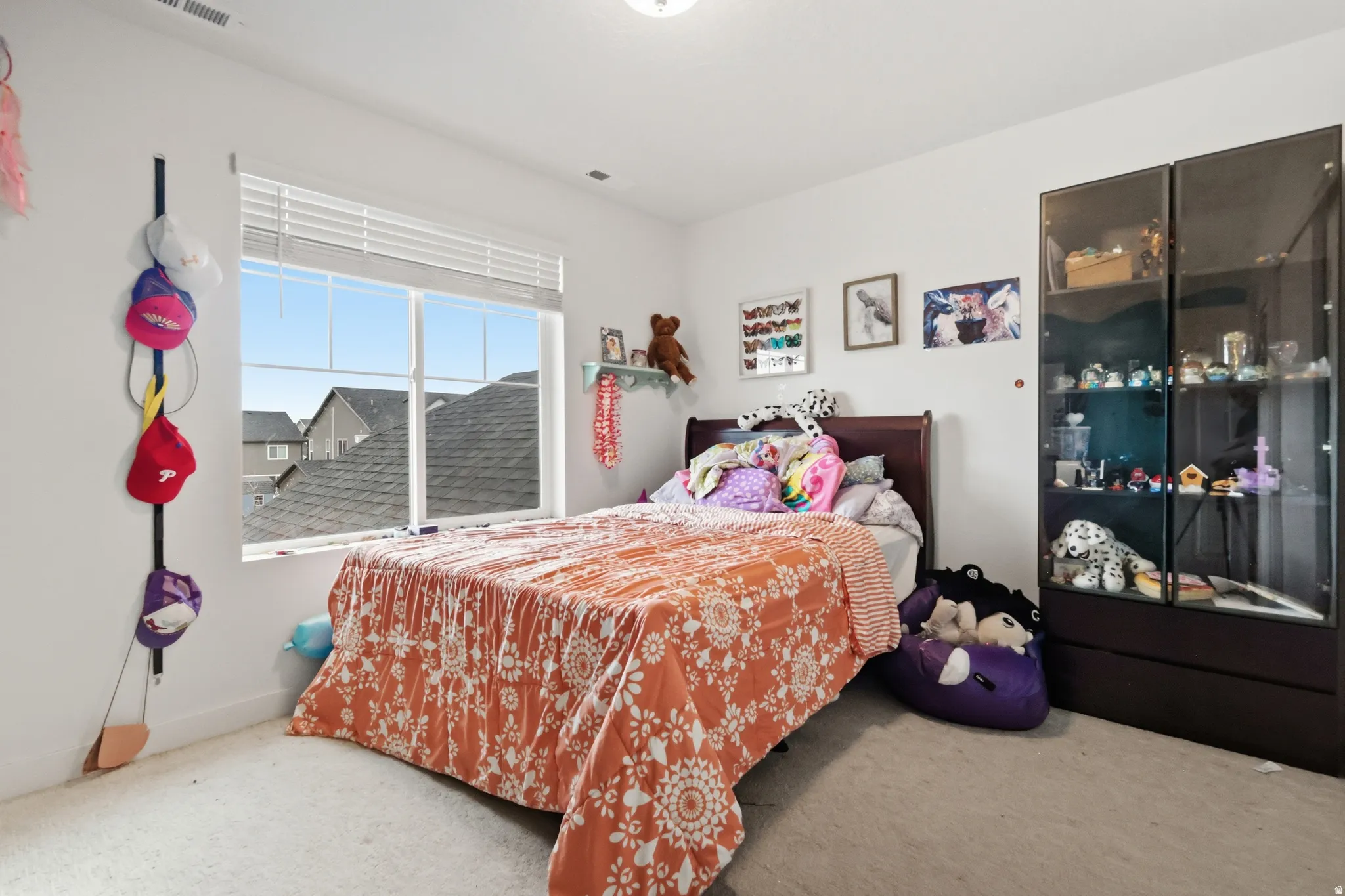 Carpeted bedroom featuring a closet and baseboards