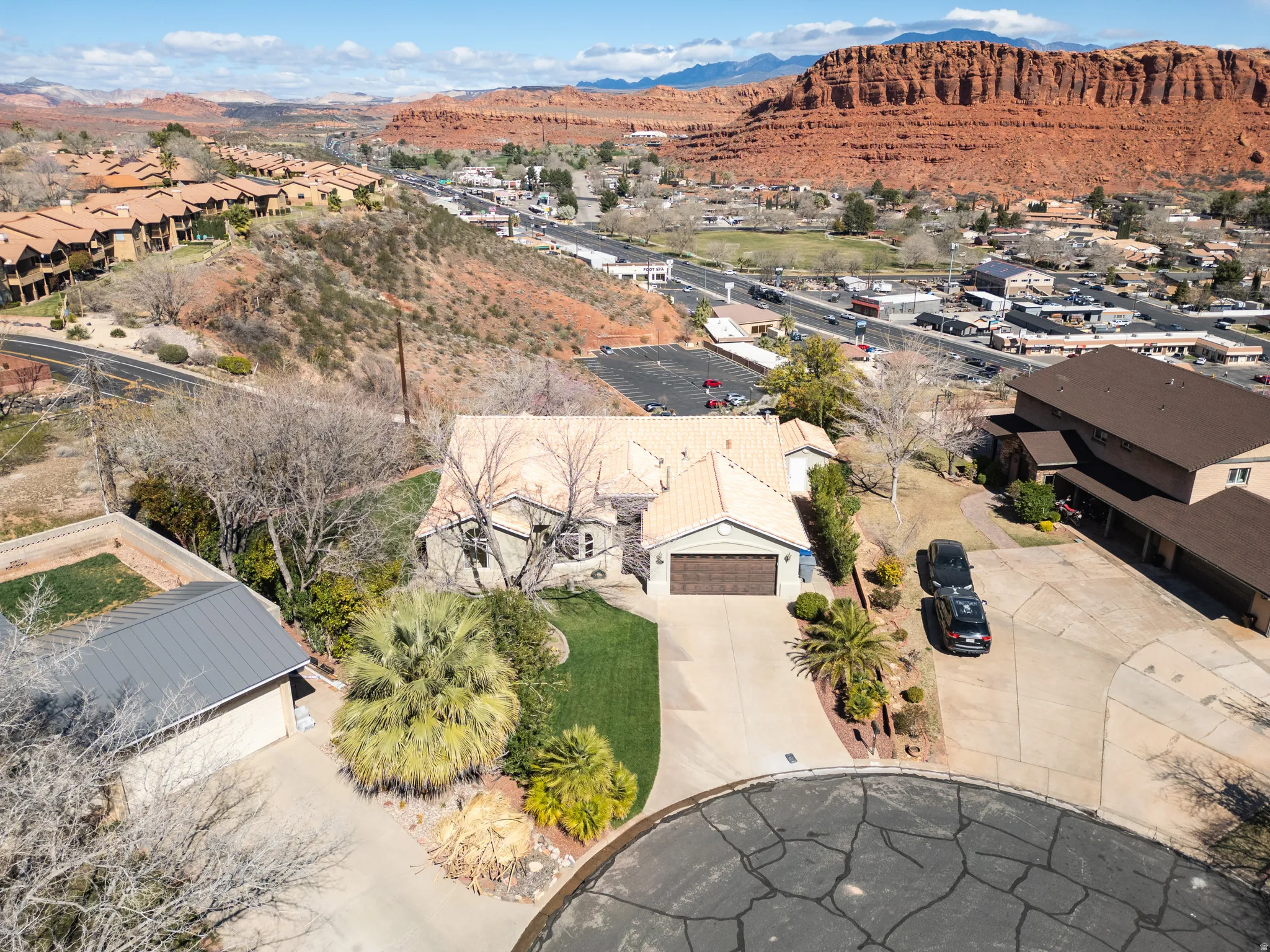 Aerial perspective of suburban area with a mountainous background