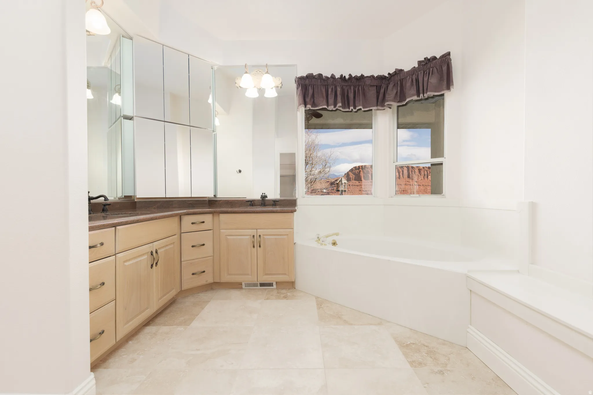 Full bathroom featuring double vanity and a bath