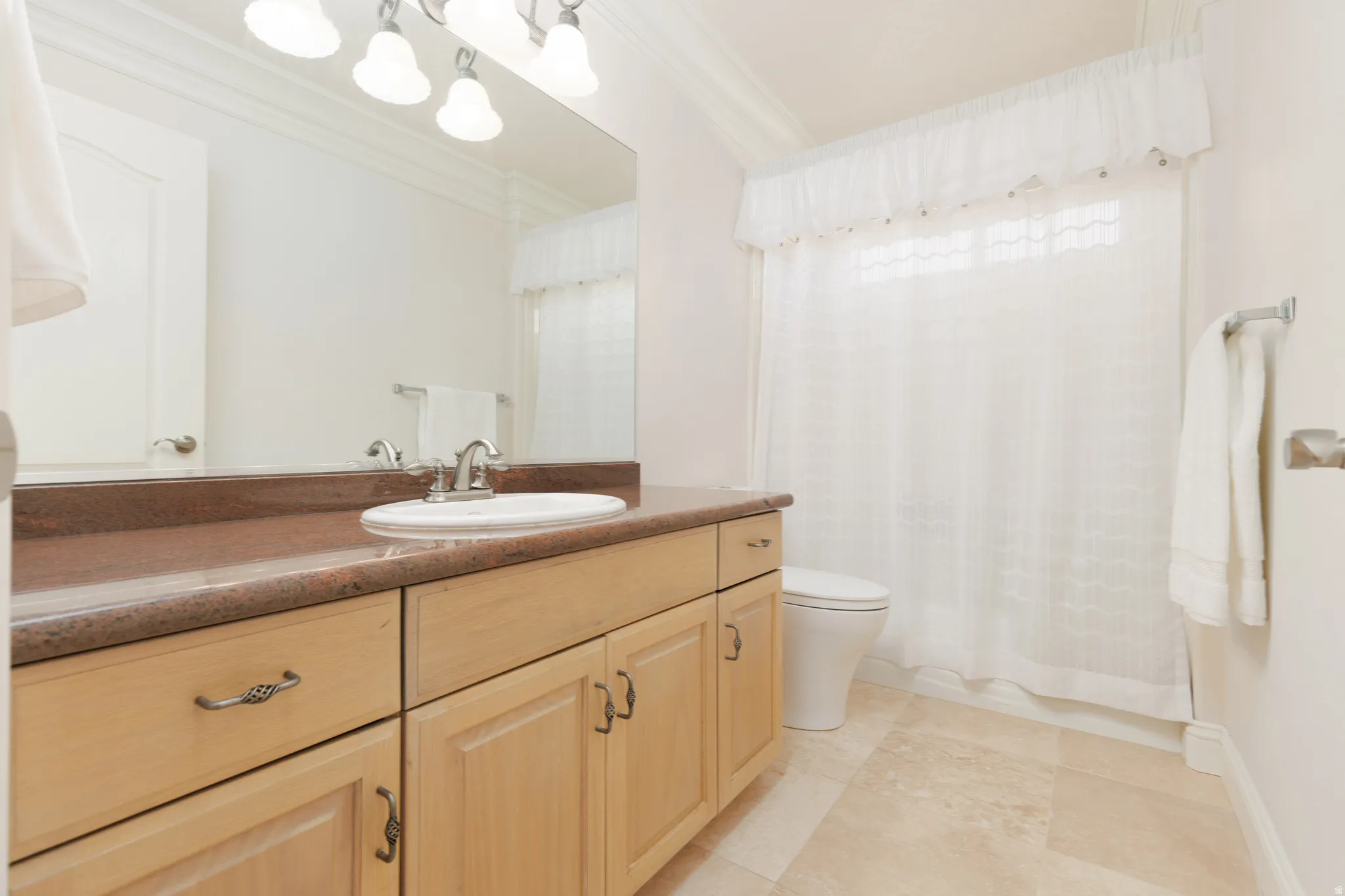 Full bathroom with vanity and ornamental molding