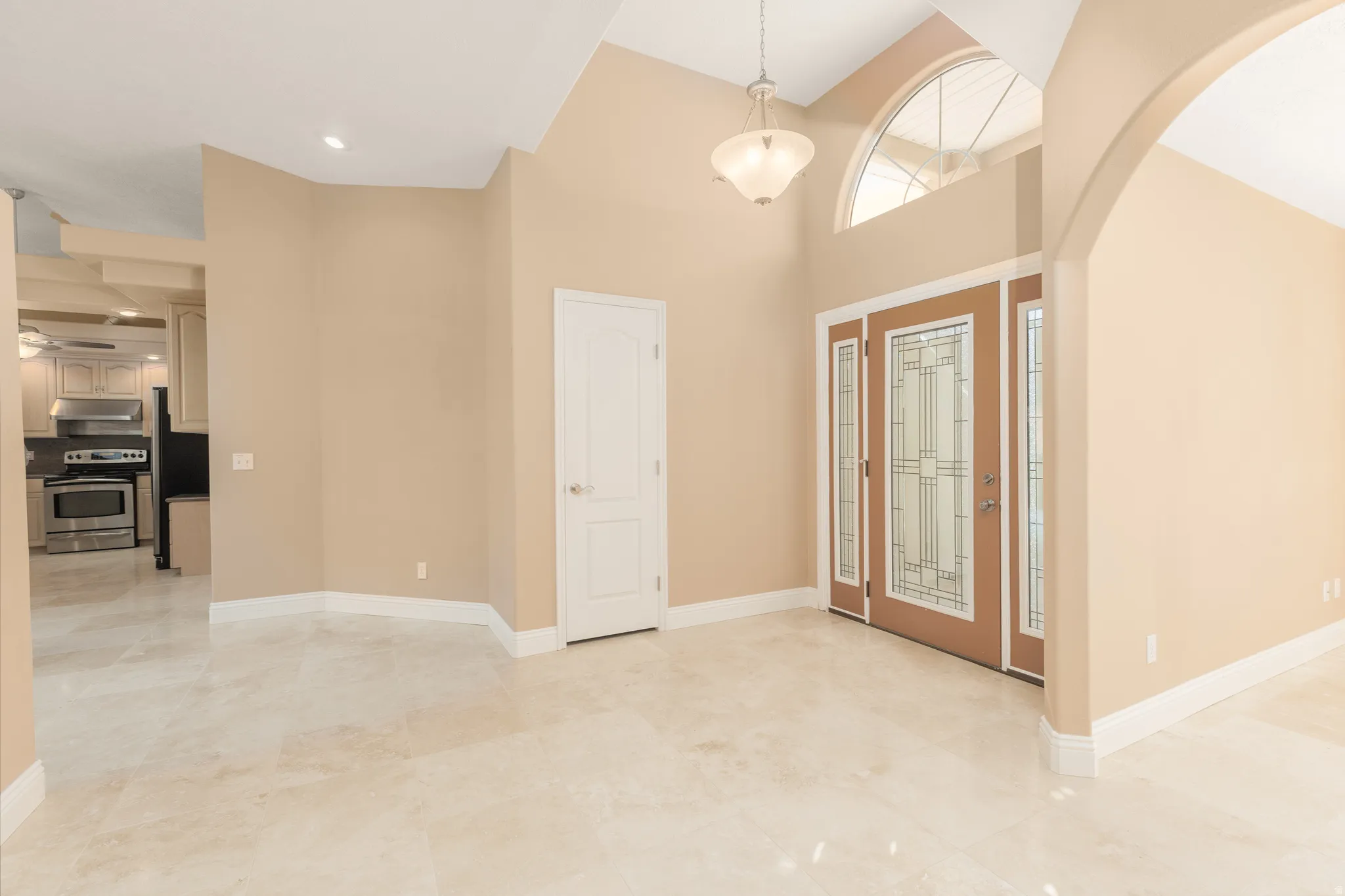 Foyer with arched walkways and a high ceiling