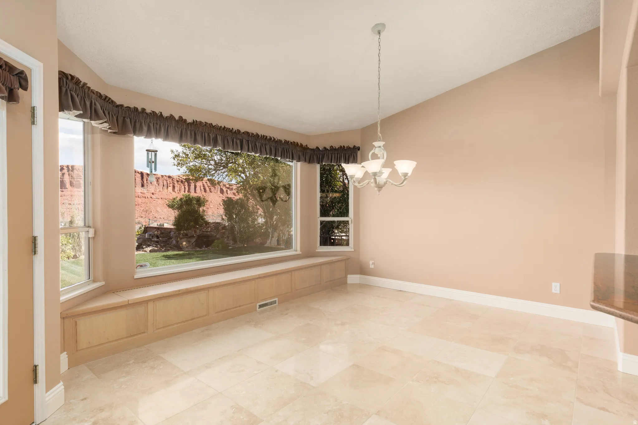 Unfurnished dining area with vaulted ceiling and a chandelier