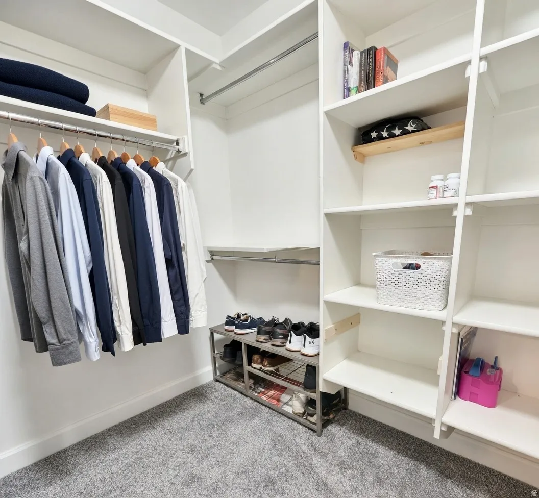 Walk in closet with light carpet