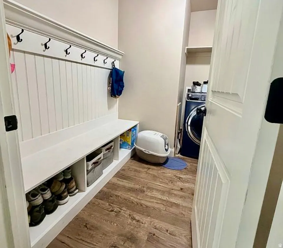 Mudroom featuring light wood finished floors and washer / dryer