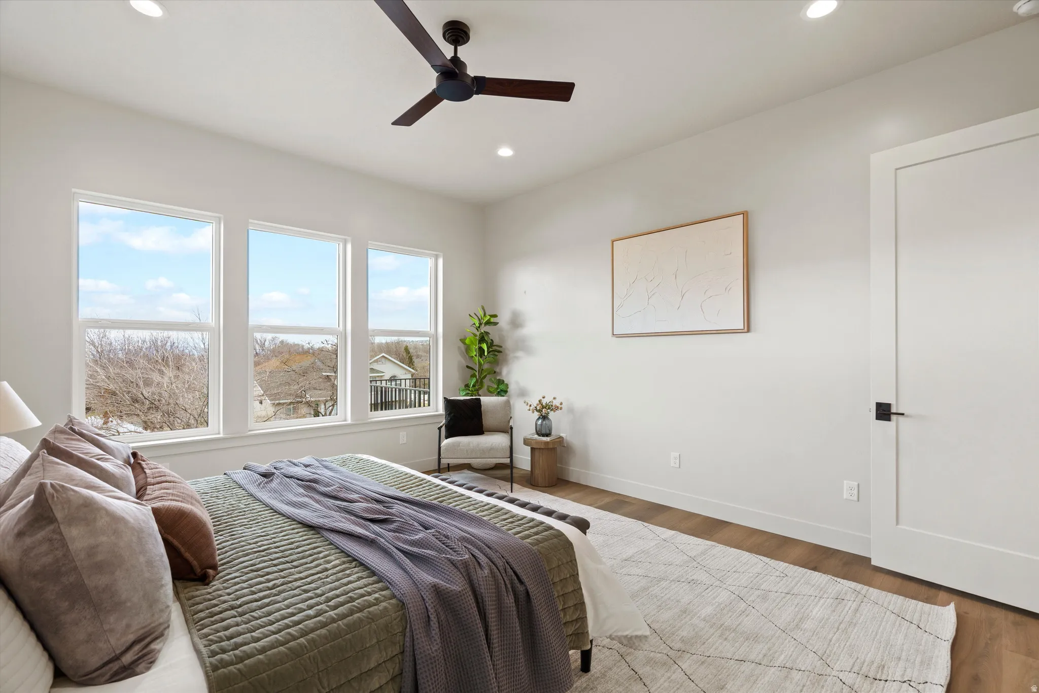Bedroom with wood finished floors, ceiling fan, and recessed lighting