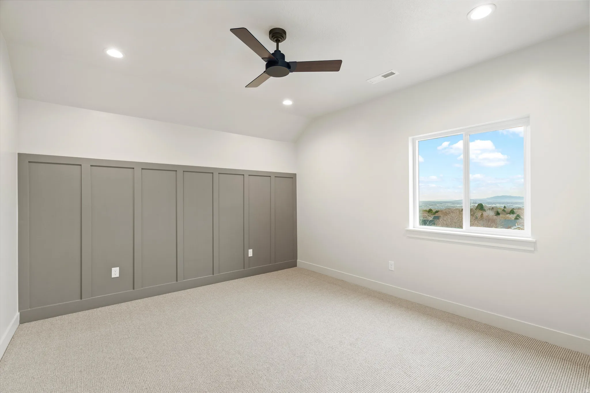 Unfurnished bedroom featuring light colored carpet, a ceiling fan, recessed lighting, a closet, and lofted ceiling