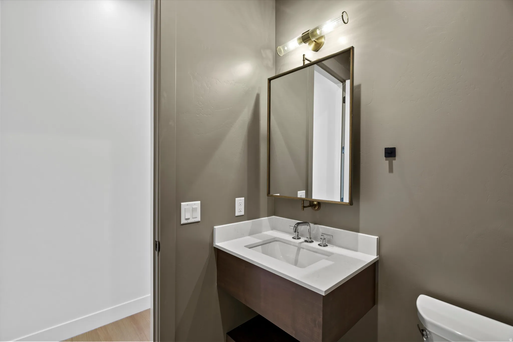 Half bath featuring vanity and toilet