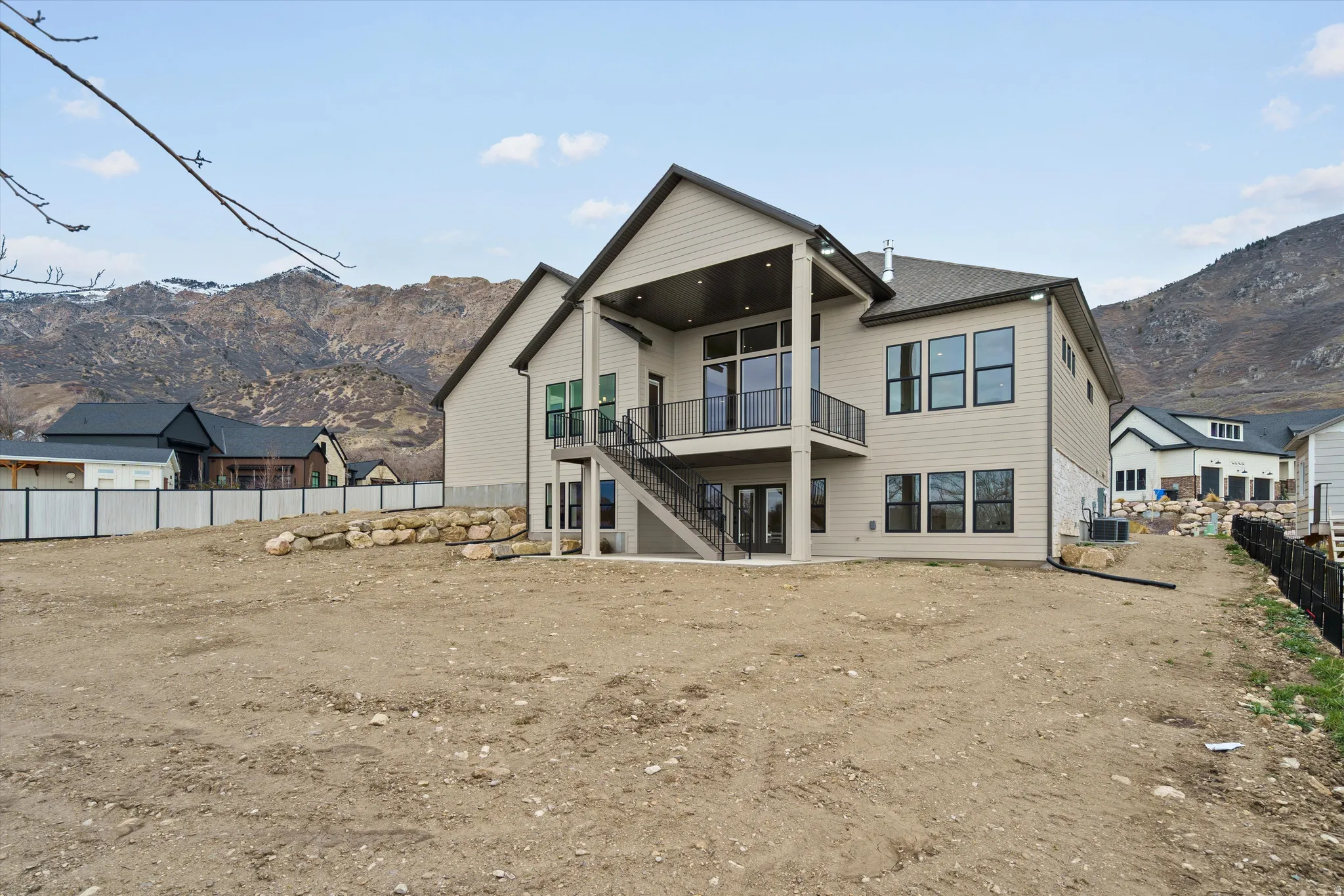 Rear view of property featuring a mountain view and a patio area
