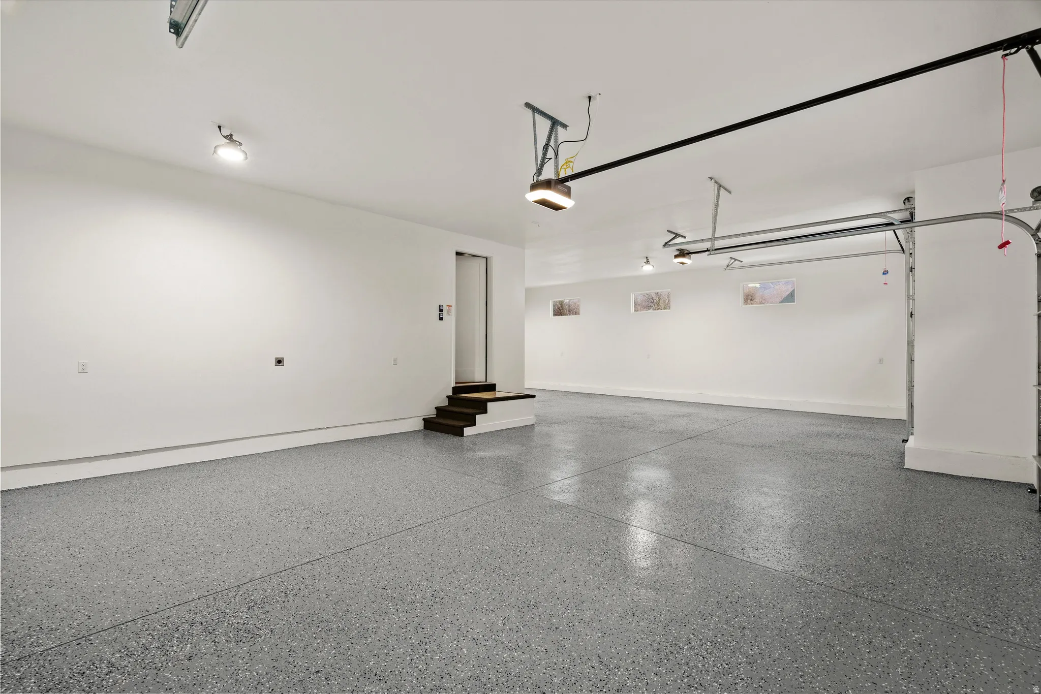 Garage featuring baseboards