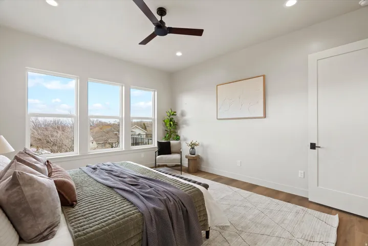 Bedroom with wood finished floors, ceiling fan, and recessed lighting