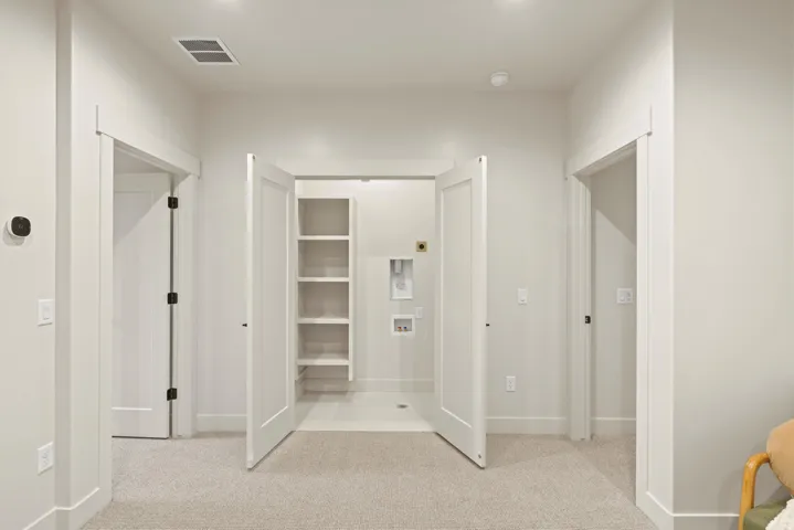 Unfurnished bedroom featuring light colored carpet