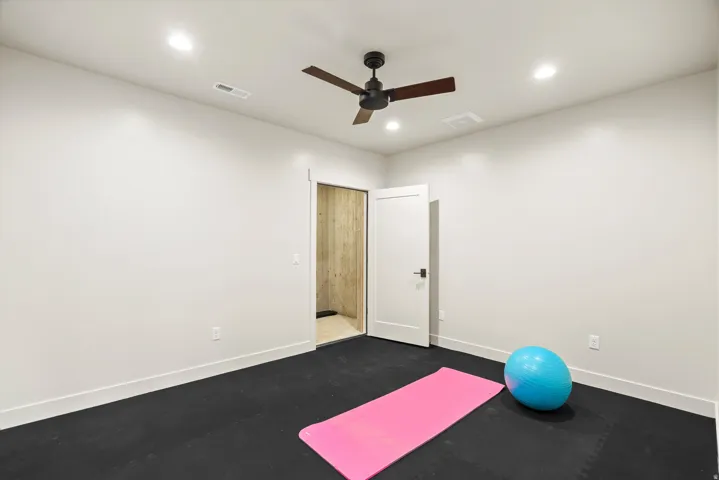 Workout area featuring a ceiling fan and recessed lighting