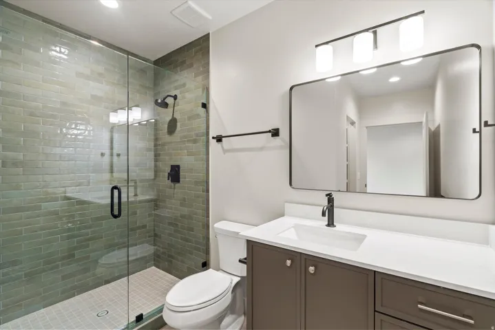 Bathroom with vanity, a stall shower, and recessed lighting