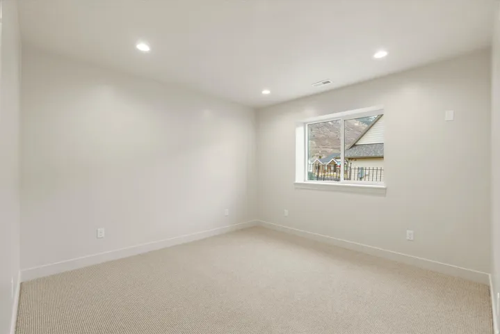Spare room featuring light carpet and recessed lighting