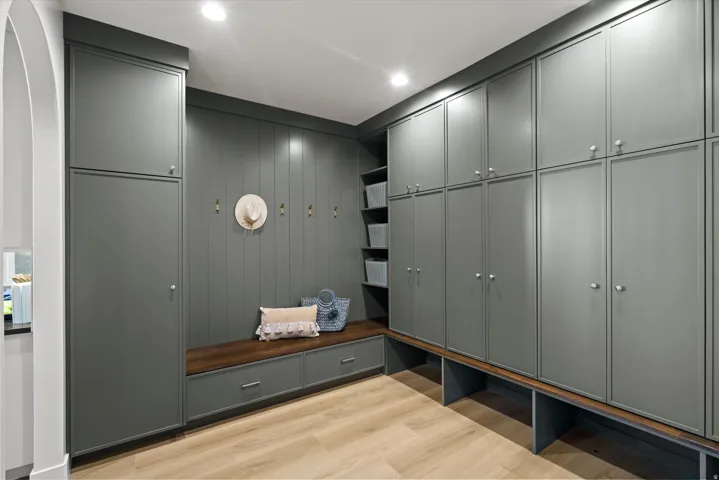 Mudroom with light wood finished floors, recessed lighting, and arched walkways