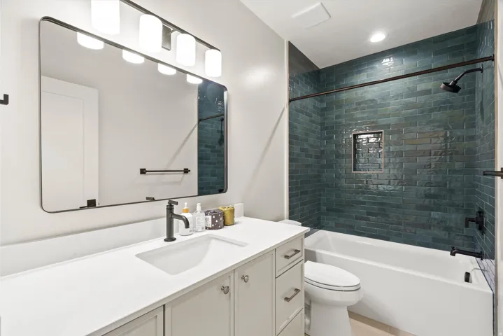 Full bathroom with vanity, bathtub / shower combination, and recessed lighting