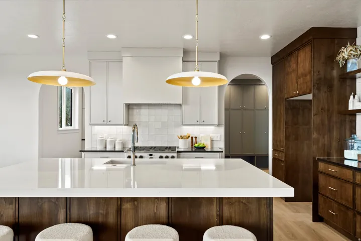Kitchen with a kitchen bar, parquet floors, and dark stone countertops