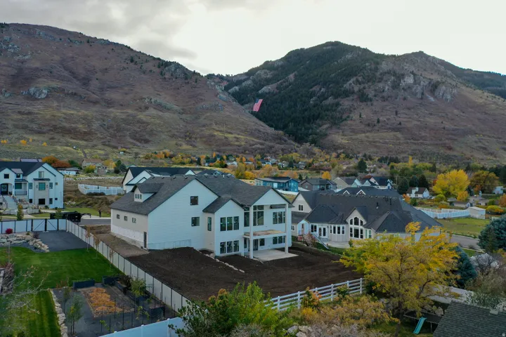 View of mountain backdrop featuring nearby suburban area